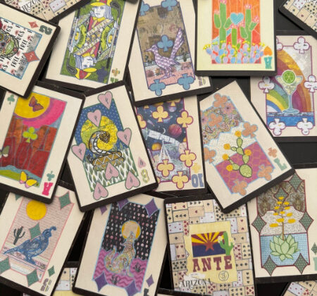 Spread of Arizona ANTE playing cards showing multiple collage faces and patterned backs on a table