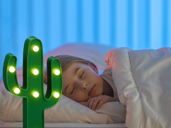 Young girl sleeping peacefully with the desert-themed night light as her night companion, available at Tucson Gallery.