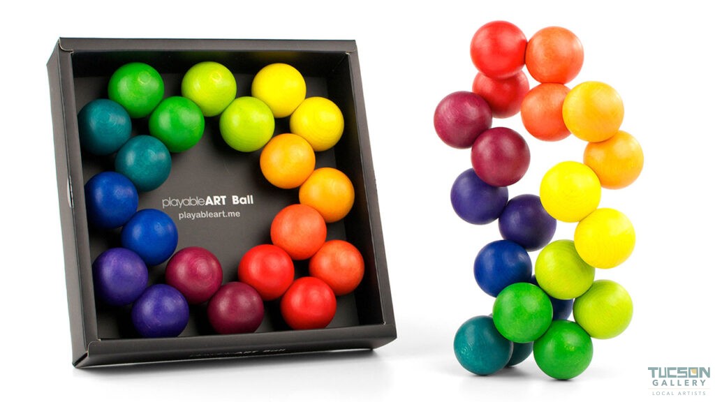 Playable ART Ball packaged in a clear gift box with colorful wooden spheres