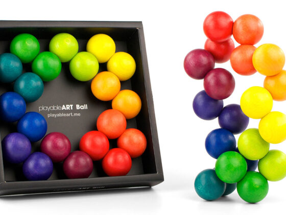 Playable ART Ball packaged in a clear gift box with colorful wooden spheres