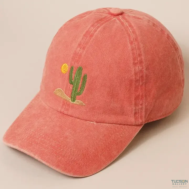 Burnt orange washed cotton dad cap with embroidered cactus and sun, a Tucson Gallery gift and souvenir.
