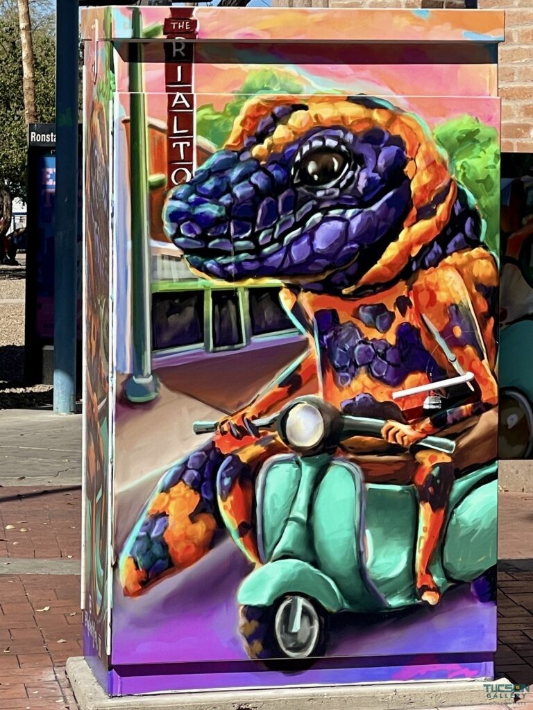 Pen Macias utility box art showing a colorful Gila monster riding a scooter in Downtown Tucson